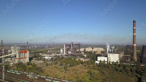 Wallpaper Mural Blue sky with white clouds against the background of a metallorgic plant smoking with black smoke. Production of iron and steel. Environmental pollution. Torontodigital.ca