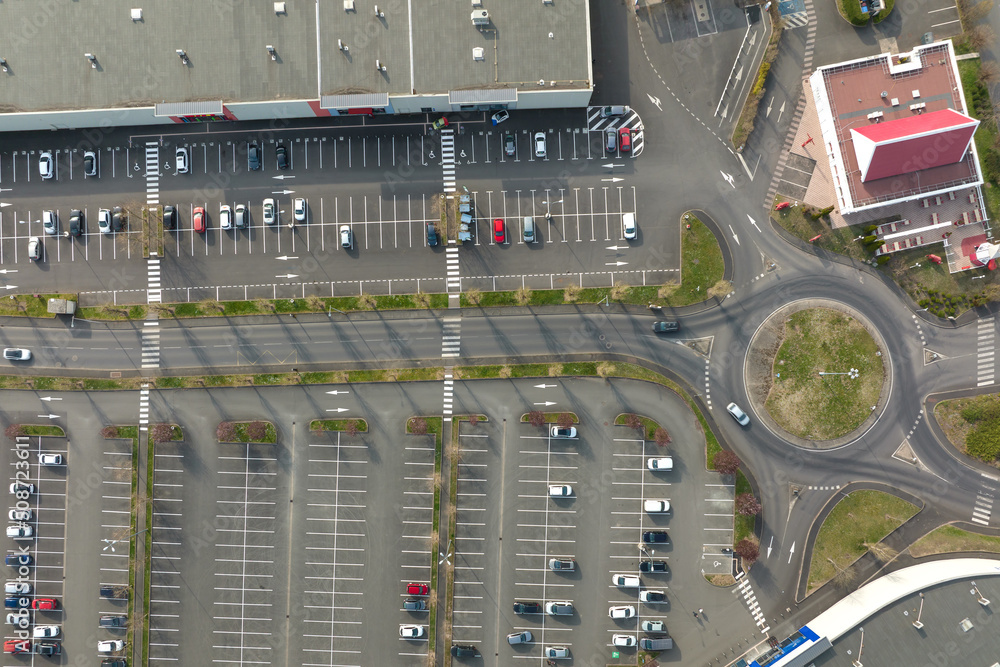 Aerial view of many colorful cars parked on parking lot with lines and markings for parking places and directions Aerial view of many colorful cars parked on parking lot with lines and markings for parking places and directions