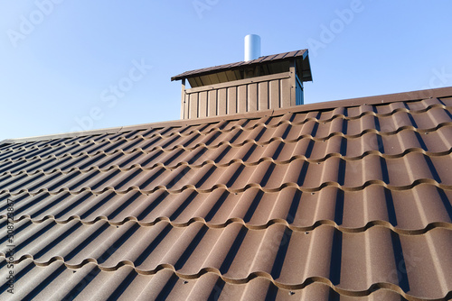 Closeup of house roof top covered with metallic shingles