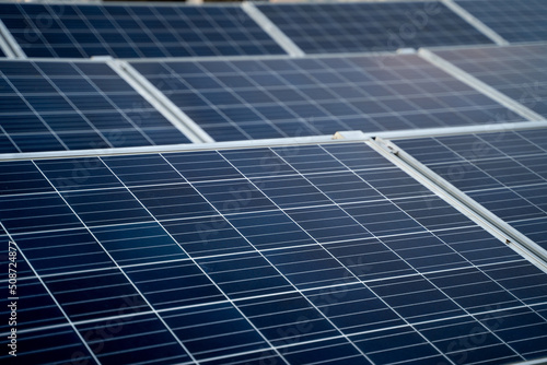 Solar panels located on the roof of the block. Green energy in modern city.