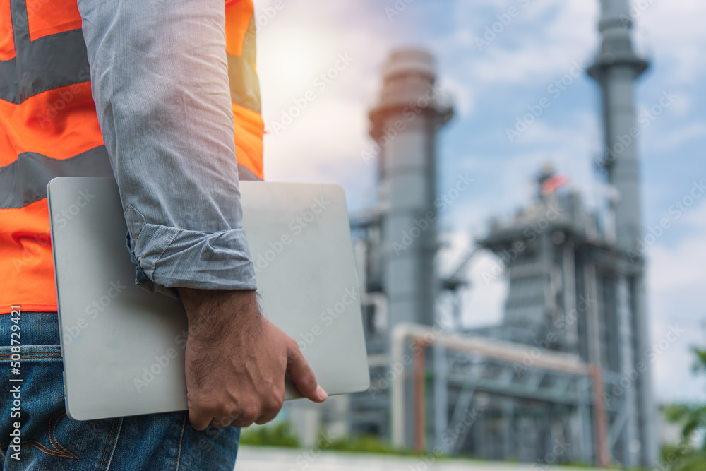 worker holding Laptop. construction worker on a site. Engineer working