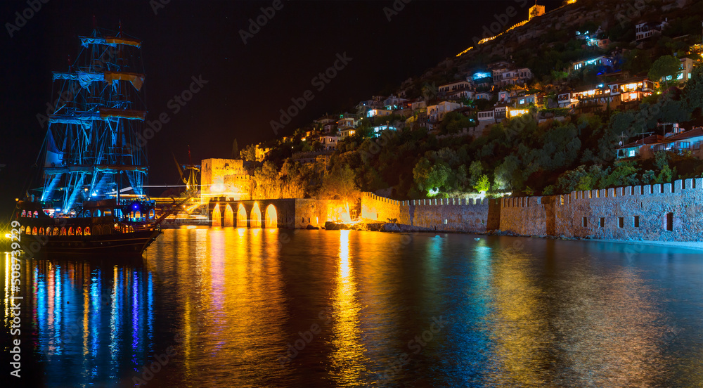 A pirate tourist ship at anchor near ancient shipyard at night - Alanya, Turkey