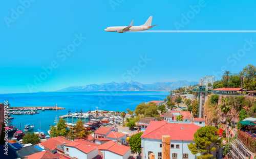 Fototapeta Naklejka Na Ścianę i Meble -  White an air plane fly over the Old Town Kaleici - Antalya, Turkey