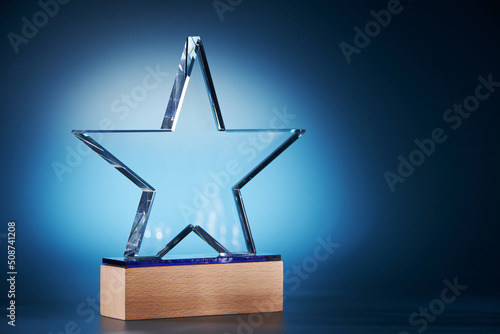 crystal star shape trophy against blue background