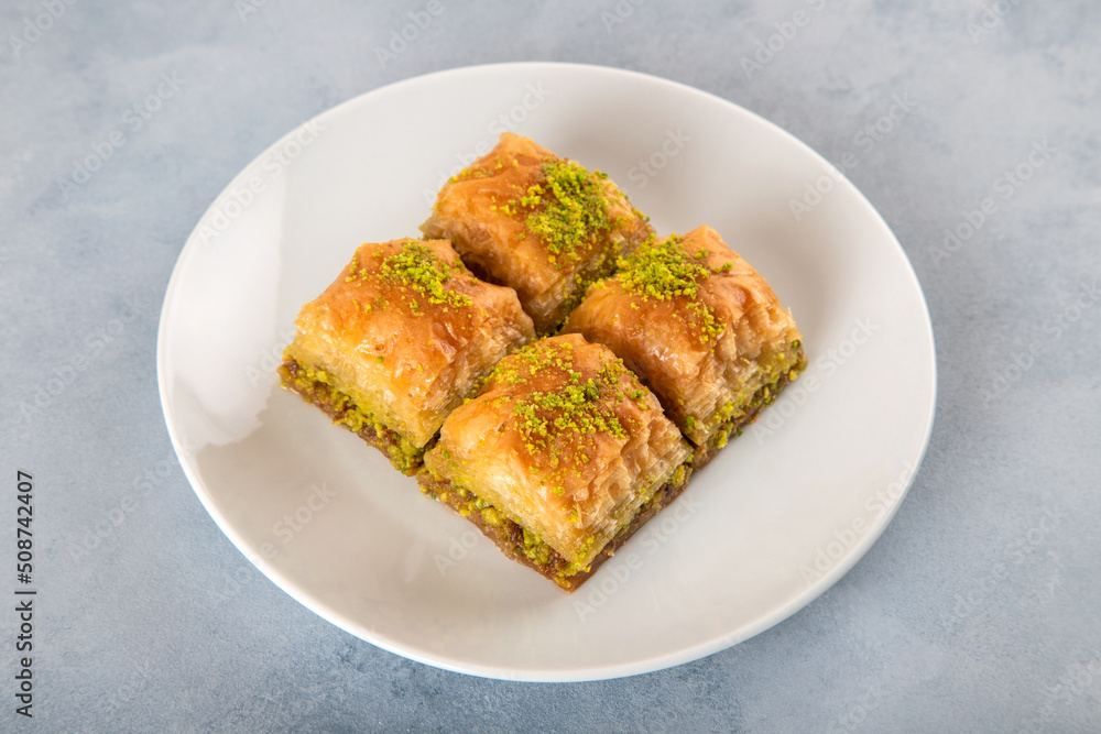 Pistachio baklava on a white plate Pistachio baklava on a white plate