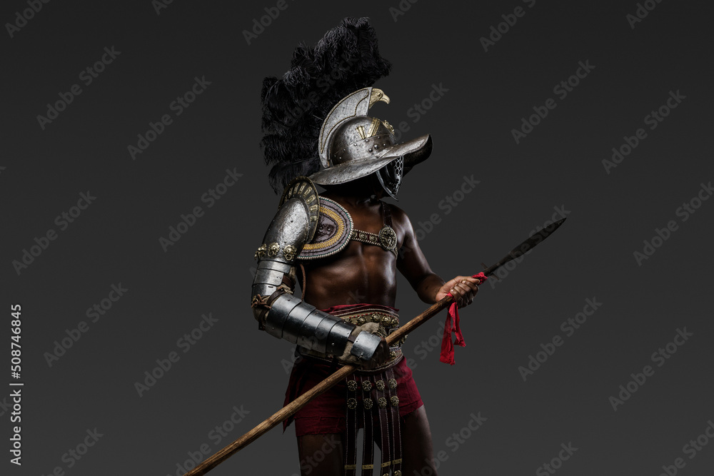 Photo of antique arena fighter of african descent dressed in plumed helmet and armor holding spear. Photo of antique arena fighter of african descent dressed in plumed helmet and armor holding spear.