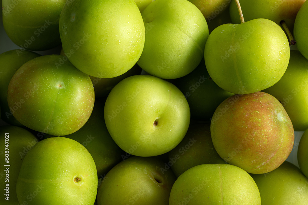 Full screen Stacked Fresh Green Plum (Japanese apricot) background Full screen Stacked Fresh Green Plum (Japanese apricot) background