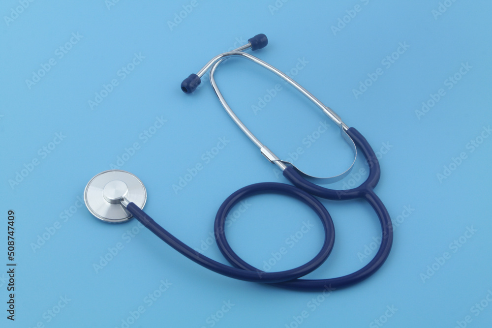Stethoscope on blue background close-up. Symbol of medicine and medical exam. Stethoscope on blue background close-up. Symbol of medicine and medical exam.
