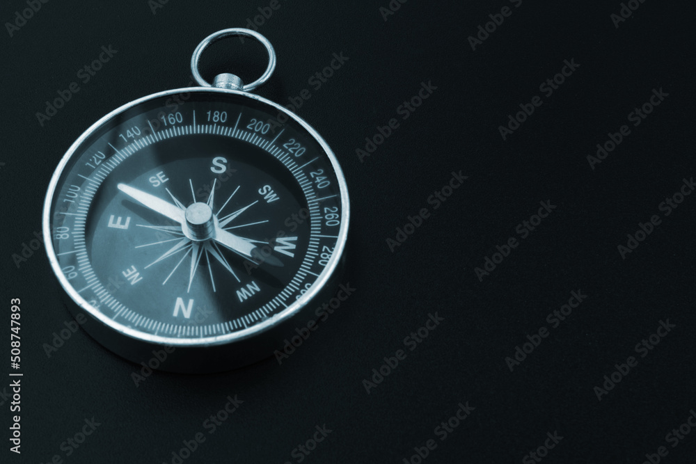 Round compass on black background, copy space for text. Trip and find destination concept. Round compass on black background, copy space for text. Trip and find destination concept.