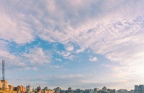 The gorgeous morning sky over the city. Sunrise over the urban district. Aerial view. Typical modern residential area. Kyiv. Ukraine. Wide panorama.