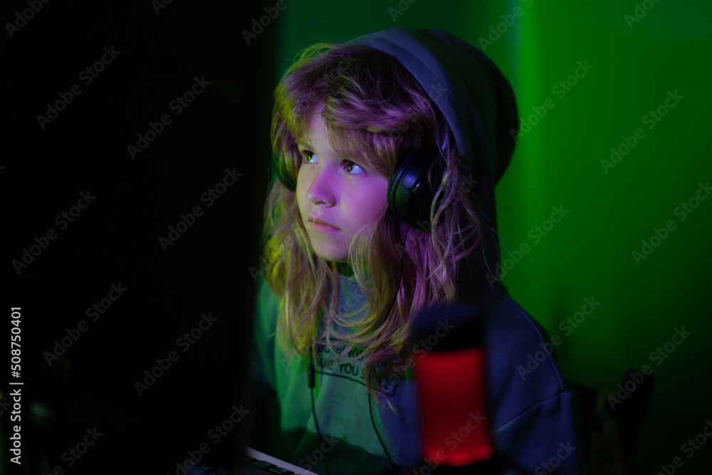 Little hacker, young programmer. Night surf in the Internet. Little child gamer play computer game on desktop. Gaming stream and blogging for kids. Little hacker, young programmer. Night surf in the Internet. Little child gamer play computer game on desktop. Gaming stream and blogging for kids.
