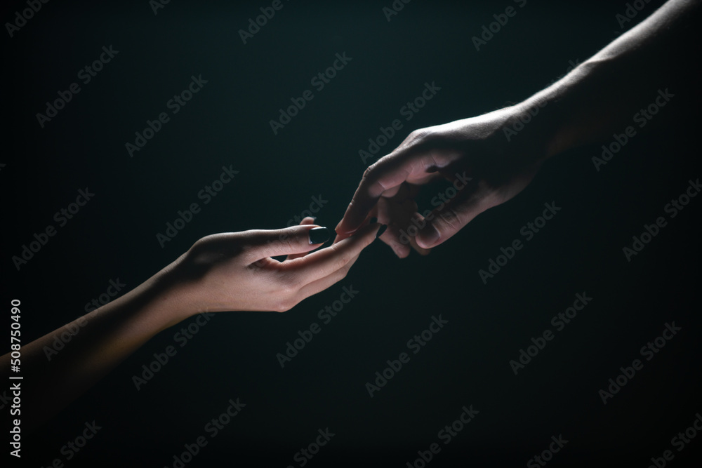 Two hands reaching toward. Tenderness, tendet touch hands in black background. Romantic touch with fingers, love. Hand creation of adam. - obrazy, fototapety, plakaty 