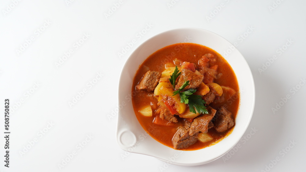 Beef goulash, soup and a stew, made of beef chuck steak, potatoes and plenty of paprika. Hungarian traditional meal. Beef goulash, soup and a stew, made of beef chuck steak, potatoes and plenty of paprika. Hungarian traditional meal.