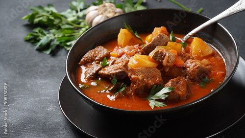 Beef goulash, soup and a stew, made of beef chuck steak, potatoes and plenty of paprika. Hungarian  traditional meal. © Natalia Hanin