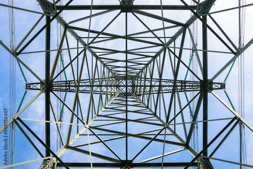 Obraz premium Electricity pylon photographed from below. Extreme low angle view.