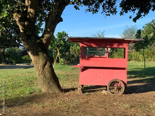 Empty old wooden food cart under the tree in the park