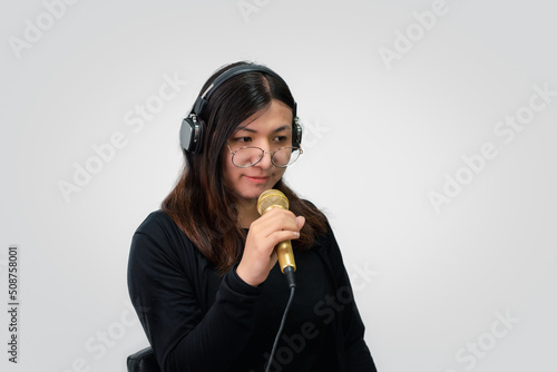 Woman (LGBTQ) singer sing a song with microphone photo