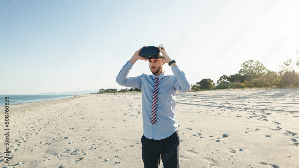 Business man in shirt wears virtual reality glasses at the beach Business man in shirt wears virtual reality glasses at the beach