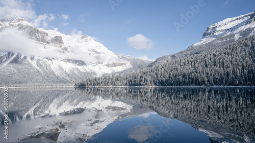 Still alpine lake reflecting its winter surroundings like a mirror, wide, Yoho N. Park, Canada © Peter Kolejak