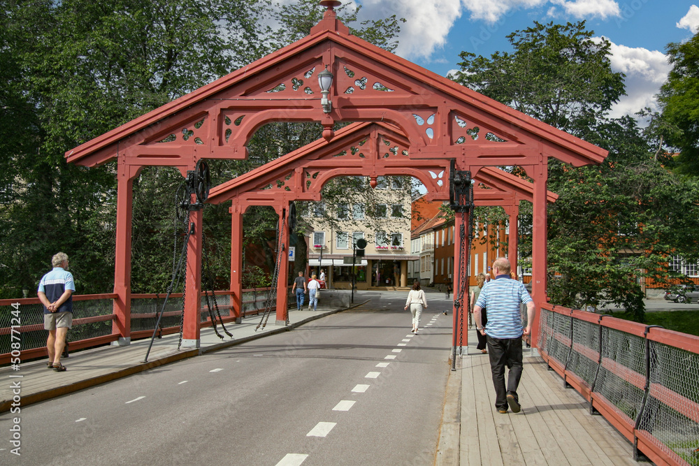 Person walking on old city bridge, Norway- Europe	