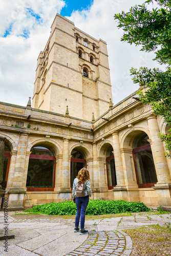 Woman contemplating the majestic height of the tower of the cathedral of Zamora.