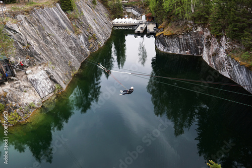 A man jumping from a bungee over a canyon in the Ruskeala mountain park in Karelia, Russia