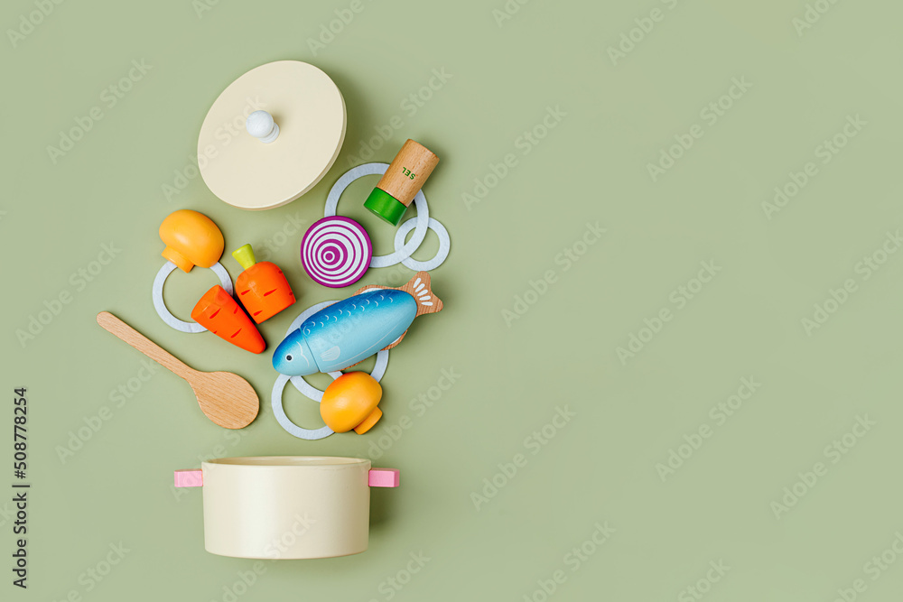 Saucepan with soup ingredients. Wooden fruit and vegetables play set