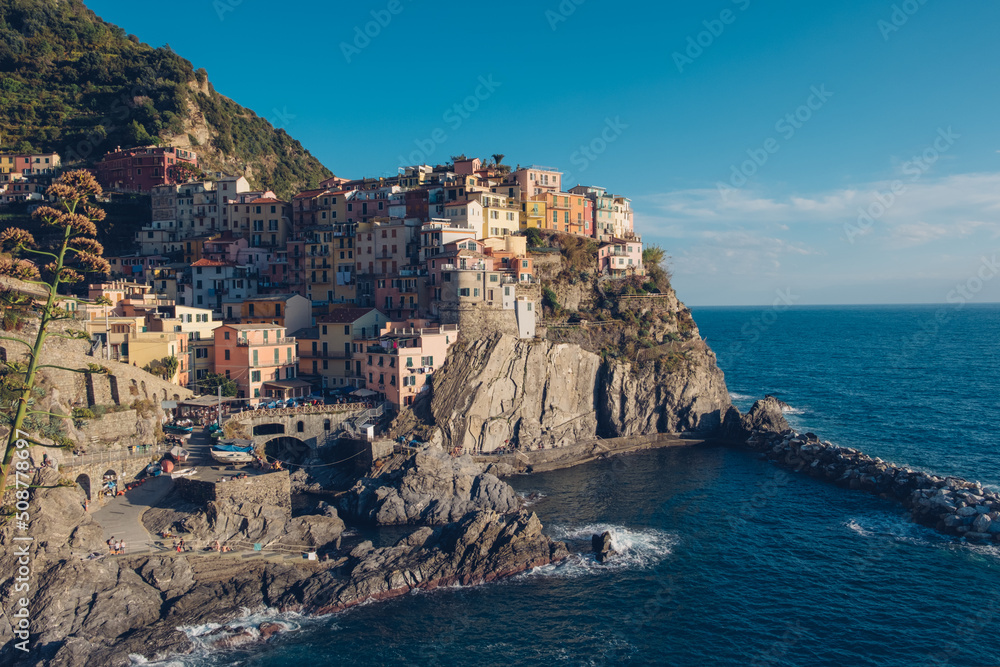 Beautiful view of rocky hills and colorful historic buildings of Manarola, tourist attraction and famous place in Liguria, Italy.