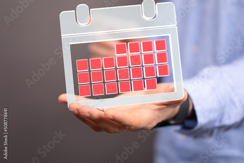 Minimal calendar icon with hand isolate on soft pink background. Paper calendar icons. Calendar date 3d