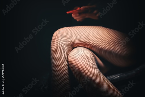 Girl in stockings against dark background