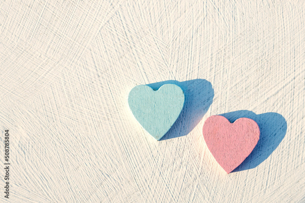 red and blue heart made of wood on a white textured surface red and blue heart made of wood on a white textured surface