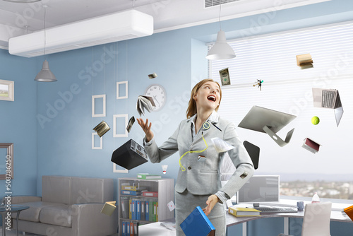 Young pretty businesswoman juggling with business items photo