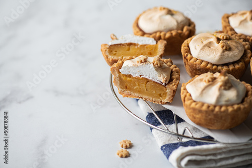 Lemon curd tartlets with whipped meringue. Copy space.
