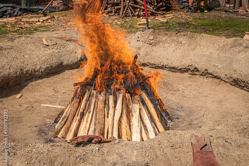 Preparation of the bonfire during the cooking process of the black clay of Gondar in Amarante, Portugal. photo