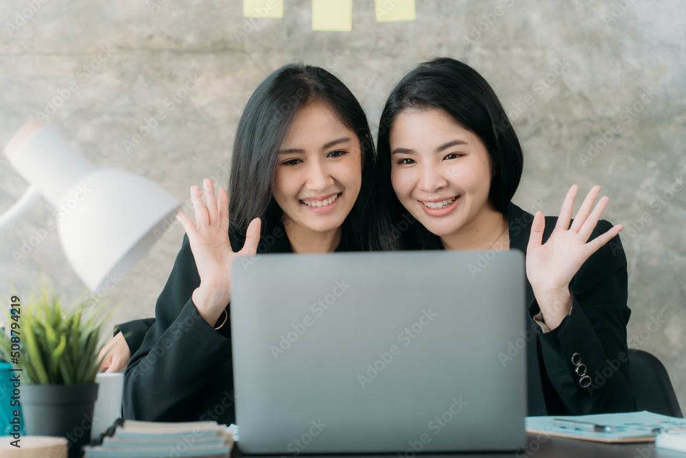 Asian woman sitting at a desk working in the office use a computer, laptop Asian woman sitting at a desk working in the office use a computer, laptop