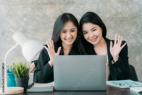 Asian woman sitting at a desk working in the office use a computer, laptop