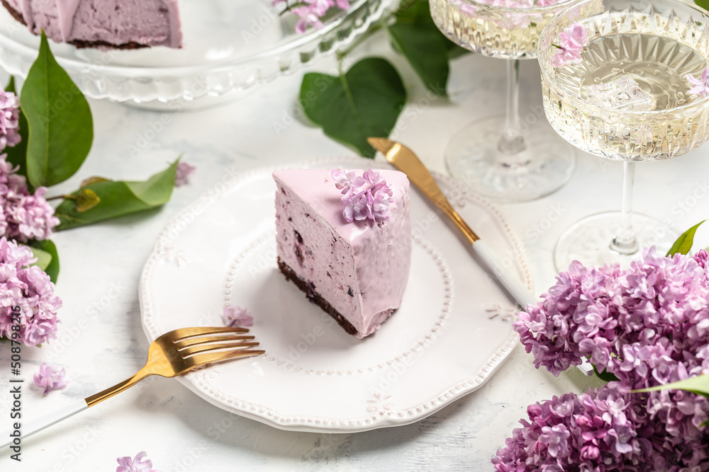a piece of mousse cake, Delicious dessert blueberry tart with fresh berries with a bouquet of purple blooming lilacs, place for text