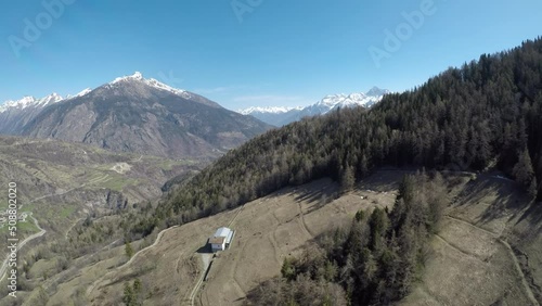 Spruce-covered hills with glimpses of Alpine mountains