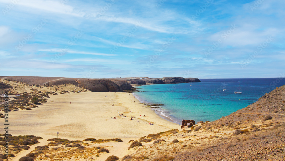 Beautiful large wide secluded idyllic empty sand beach lagoon, turquoise sea, dry hills dunes, rocks - Playa Mujeres, Ponte Papagayo, Playa Blanca - Lanzarote Beautiful large wide secluded idyllic empty sand beach lagoon, turquoise sea, dry hills dunes, rocks - Playa Mujeres, Ponte Papagayo, Playa Blanca - Lanzarote