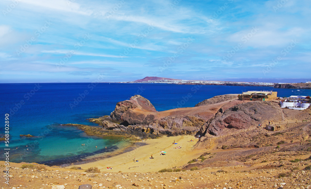 Beautiful coast landscape, secluded blue turquoise lagoon, white sand beach, dramatic red cliffs, blue sky and sea - Playa Papagayo, Playa Blanca - Lanzarote