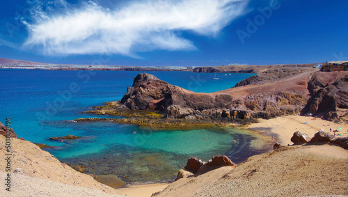 Beautiful coast landscape, secluded blue turquoise lagoon, white sand beach, dramatic red cliffs, blue sky and sea - Playa Papagayo, Playa Blanca - Lanzarote