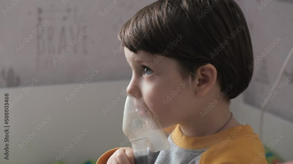 Treatment of the lungs and respiratory tract in children. The baby is being treated with an inhaler. Treatment of children at home with an inhaler. Treatment of the lungs and respiratory tract in children. The baby is being treated with an inhaler. Treatment of children at home with an inhaler.