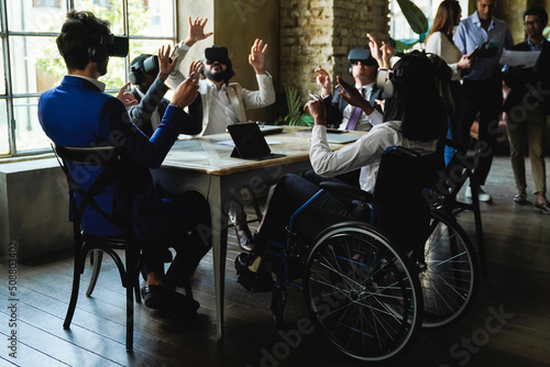 Diverse business people working with virtual reality headsets inside coworking office - Focus on African woman sitting on wheelchair