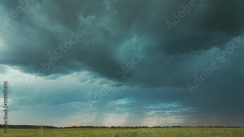 4K Sky During Rain Horizon Above Rural Wheat Landscape Field. Agricultural And Weather Forecast Concept. Storm, Thunder, thunderstorm, stormclouds, , , . Countryside Meadow In Summer Rainy Day