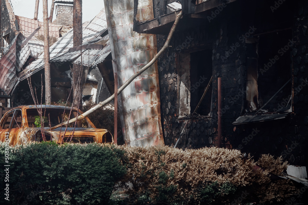 Irpin, Kyiv region, 2022. Destroyed car in the yard of a house. Consequences of rocket fire during Russia's war against Ukraine.