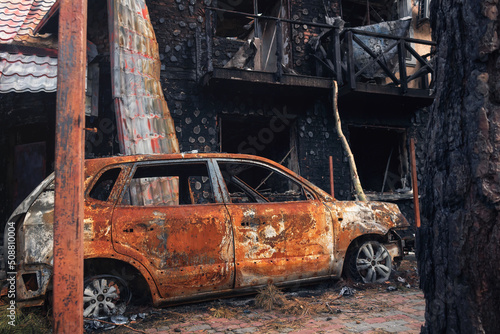 Irpin, Kyiv region, 2022. Destroyed car in the yard of a house. Consequences of rocket fire during Russia's war against Ukraine.