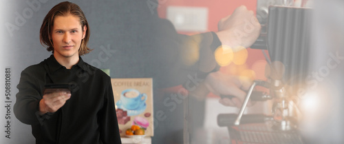  A professional barista prepares coffee in a carob coffee machine. Favorite job in the restaurant industry.A small coffee business. Makes espresso, Americano with a takeaway.