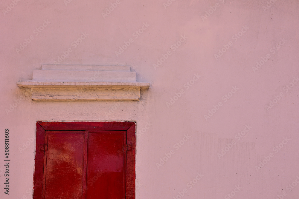 Classic red wooden window with white background.	