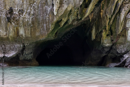 Traveler kayaking, taking photo, and relaxing at Emerald Cave or Morakot Cave. Famous cave in Mook island. Trang, South of Thailand. photo