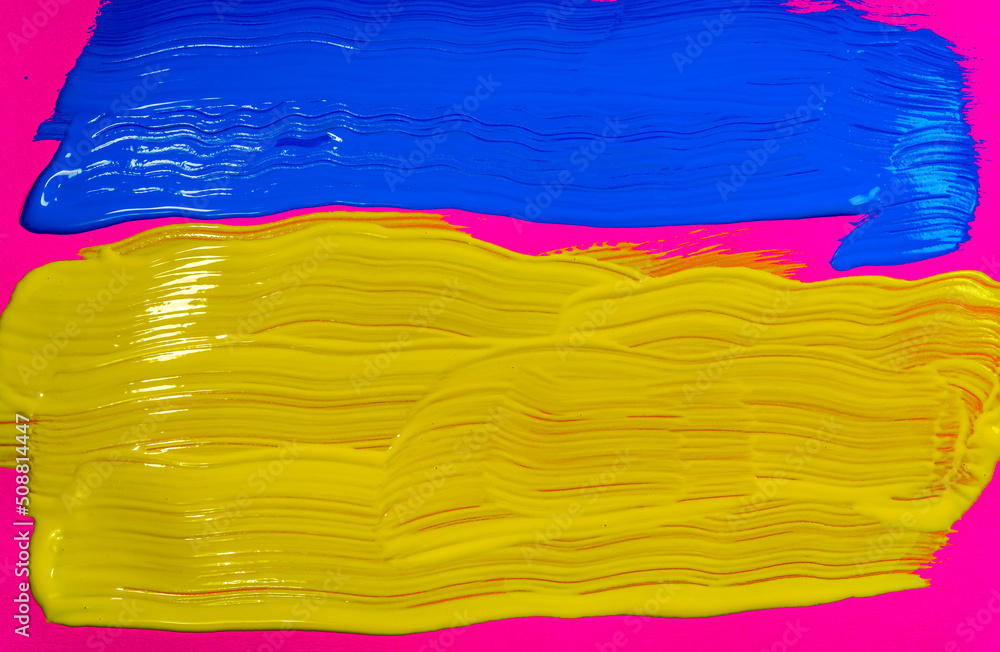 Obraz premium Yellow and blue brush strokes reflecting Ukraine national colors on fuchsia pink background .Yellow and Blue abstract image on fuchsia pink background